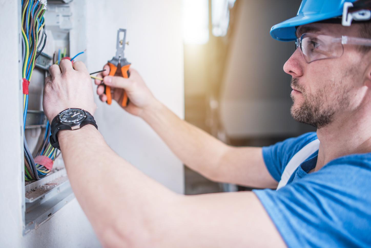 Electrician running sub-panel wiring for a pool house build